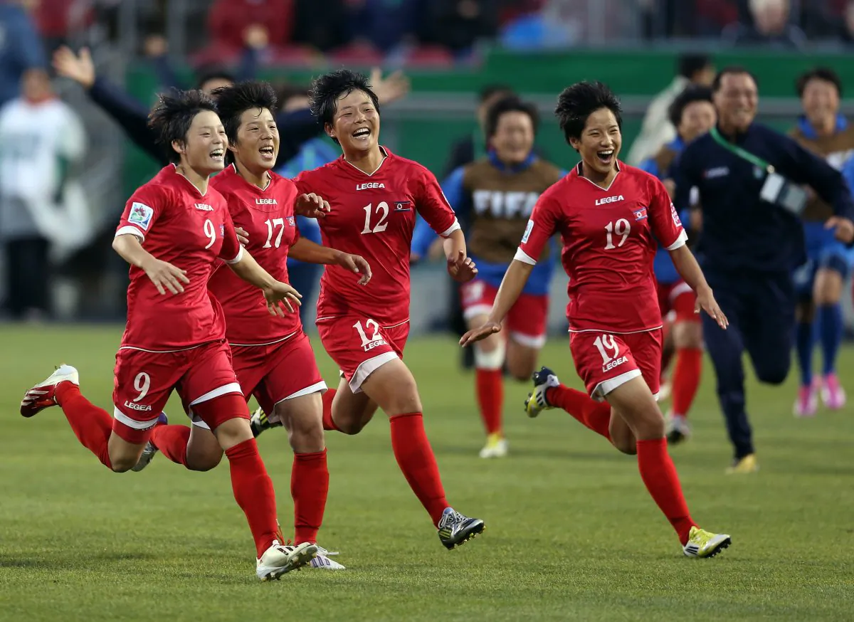Ri Un Sim, Choe Un Hwa, Jon So Yon, and Ri Kyong Hyang of North Korea celebrate victory in the shoot-out during the FIFA U-20 Women's World Cup Canada 2014 Quarter Final match with the U.S. in Toronto on Aug. 16, 2014. North Korea ultimately finished 4th in the tournament. (Vaughn Ridley/Getty Images)
