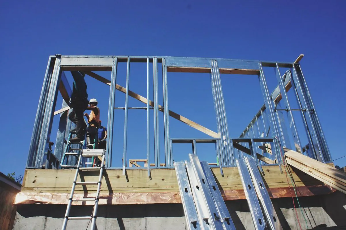 In this Aug. 27, 2014 photo provided by the New York City Mayor's Office of Housing Recovery Operations,
Carpenters work on a home that was damaged in Superstorm Sandy, in the Breezy Point section of the Queens borough of New York on Aug. 27, 2014. New York City officials say they are on target to meet the Build it Back program’s initial goal of starting 500 construction projects and sending 500 reimbursement checks by Labor Day. (AP Photo/New York City Mayor's Office of Housing Recovery Operations)