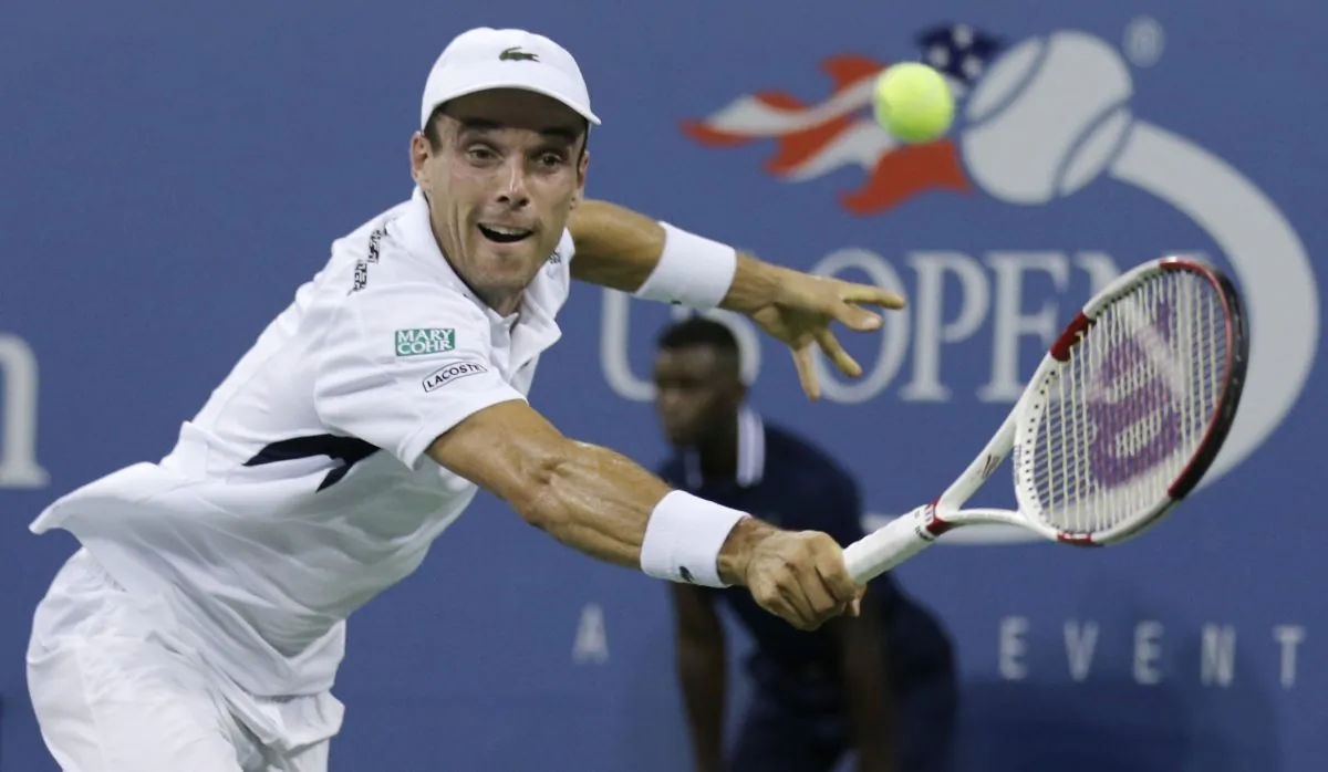 Roberto Bautista Agut, of Spain, returns to Roger Federer, of Switzerland, during the fourth round of the U.S. Open tennis tournament, Tuesday, Sept. 2, 2014, in New York. (AP Photo/Charles Krupa)