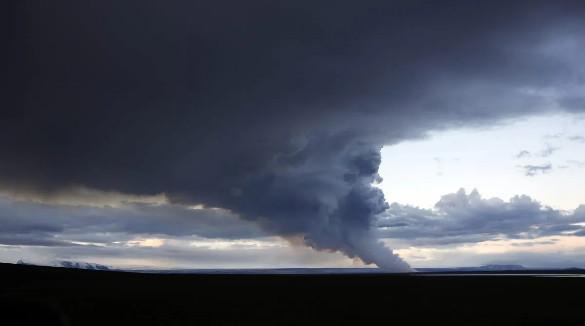 A plume of smoke rises from the lava eruption on Holuhraun, northwest of the Dyngjujoekull glacier in Iceland, Monday, Sept. 1, 2014. Lava fountains danced along a lengthy volcanic fissure near Iceland's subglacial Bardarbunga volcano Sunday, prompting authorities to raise the aviation warning code to the highest level and close the surrounding airspace. The warning was lowered 12 hours later as visibility improved and it was clear that no volcanic ash was detected. (AP Photo/Eggert Johannesson)