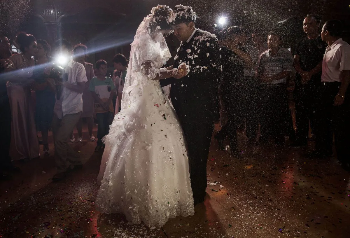 A Uyghur couple enjoy their first dance together at their wedding celebration after being married on Aug. 2, 2014, in Kashgar, Xinjiang Uyghur Autonomous Region. A new policy was announced in Xinjiang to give cash and other financial benefits for marriages between the dominant Han Chinese people and minority ethnicities. (Kevin Frayer/Getty Images)