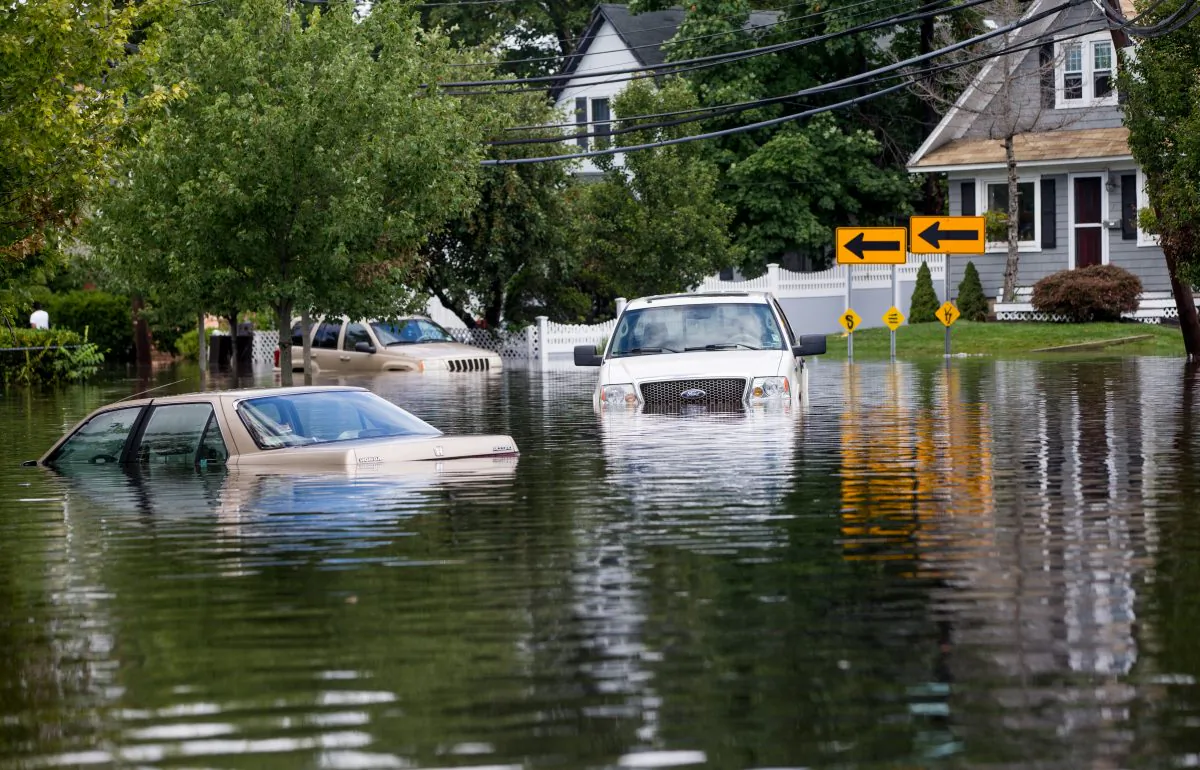 Cars are abandoned on a flooded Brooke Ave following heavy rains and flash flooding on August 13, 2014 in Bayshore, New York. (Andrew Theodorakis/Getty Images)