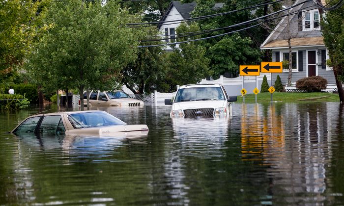 Cars are abandoned on a flooded Brooke Ave following heavy rains and flash flooding on August 13, 2014 in Bayshore, New York. (Andrew Theodorakis/Getty Images)