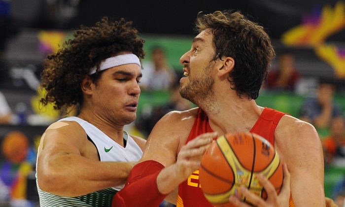 Spain center Pau Gasol and Brazil center Anderson Varejao in the previous game; Spain is now set to take on France on Wednesday. (AFP/Getty Images)