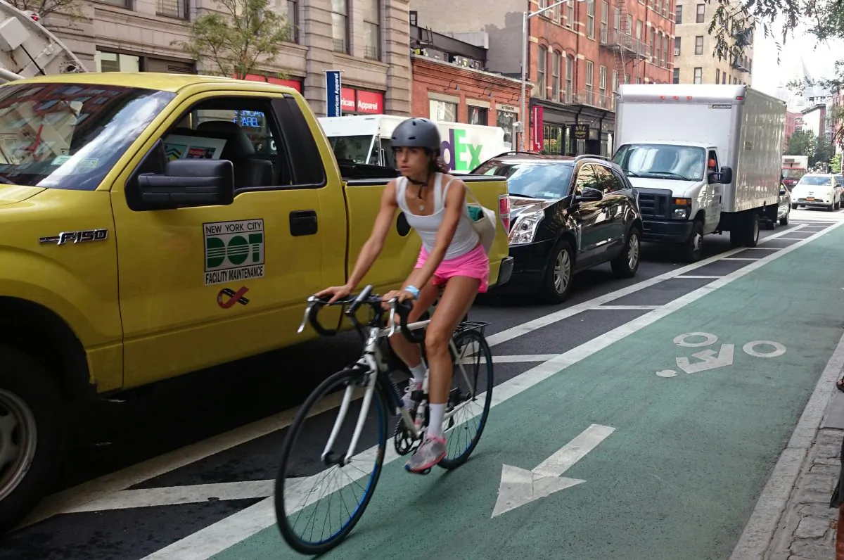A  cyclist rides on a protected bike lane on Lafayette Street in Soho, Sept. 3. 2014. (Epoch Times)