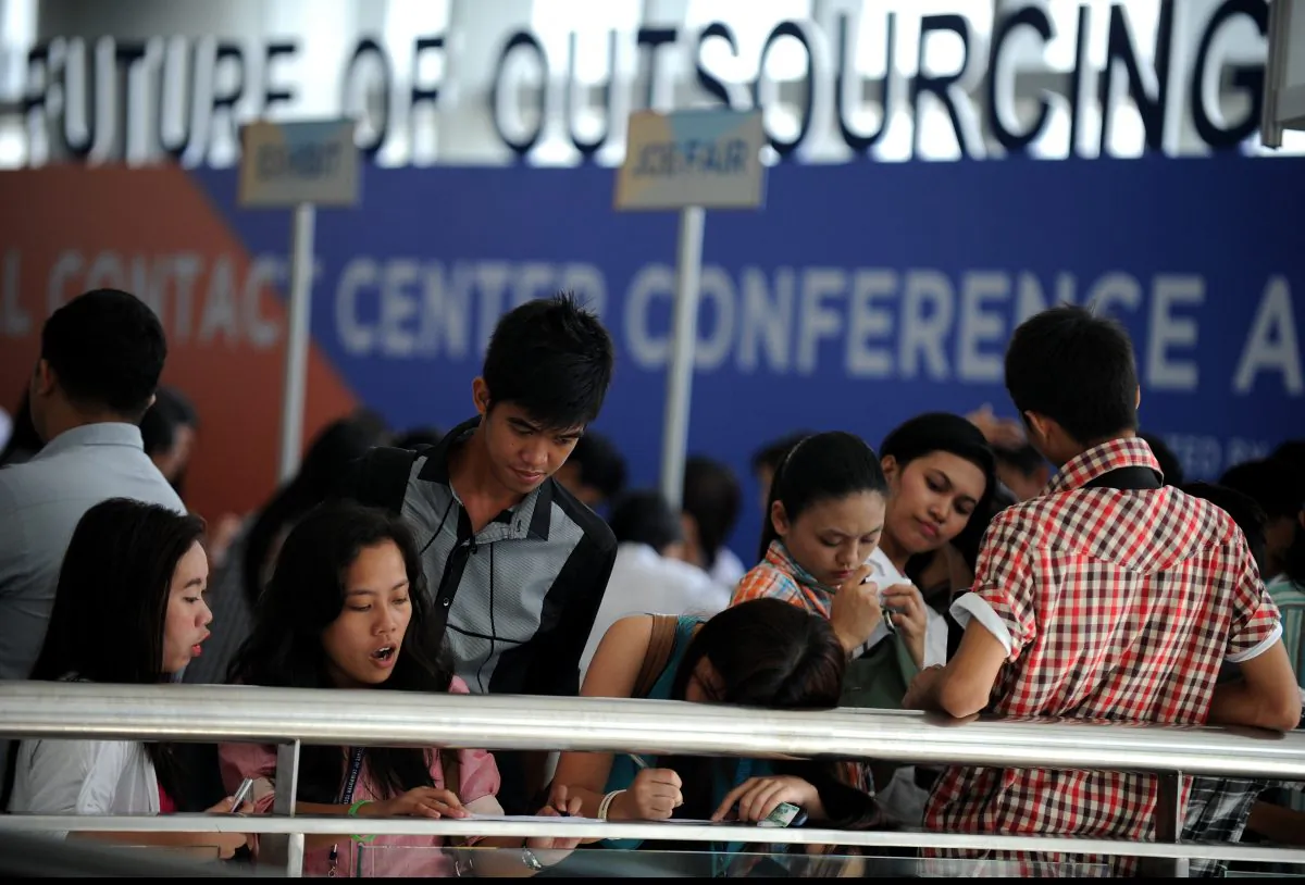 Job seekers fill in their forms at a job fair for call center agents during the International Contact Center Conference and Expo in Manila on Sept. 18, 2012. (Noel Celis/AFP/GettyImages)
