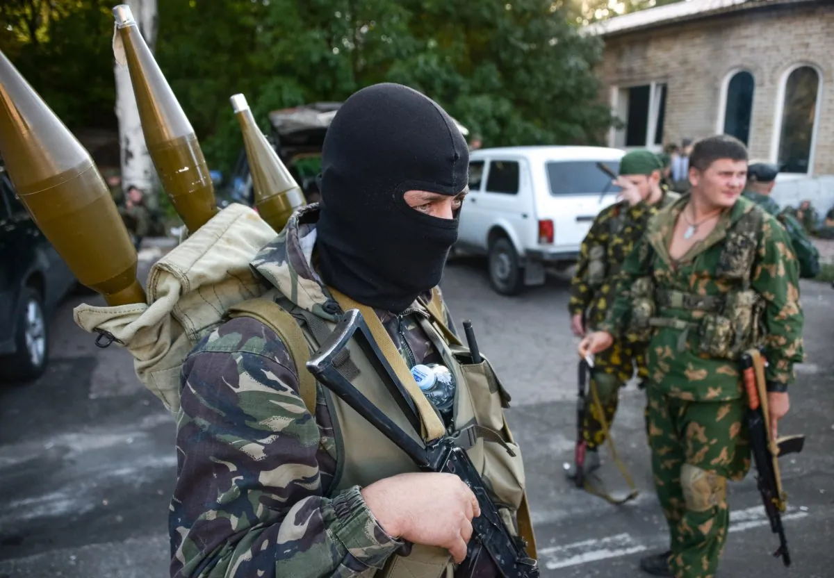 Pro-Russia rebels prepare arms for the the assault on the positions of Ukrainian army in Donetsk airport, eastern Ukraine, on Aug. 31, 2014. (AP Photo/Mstislav Chernov)