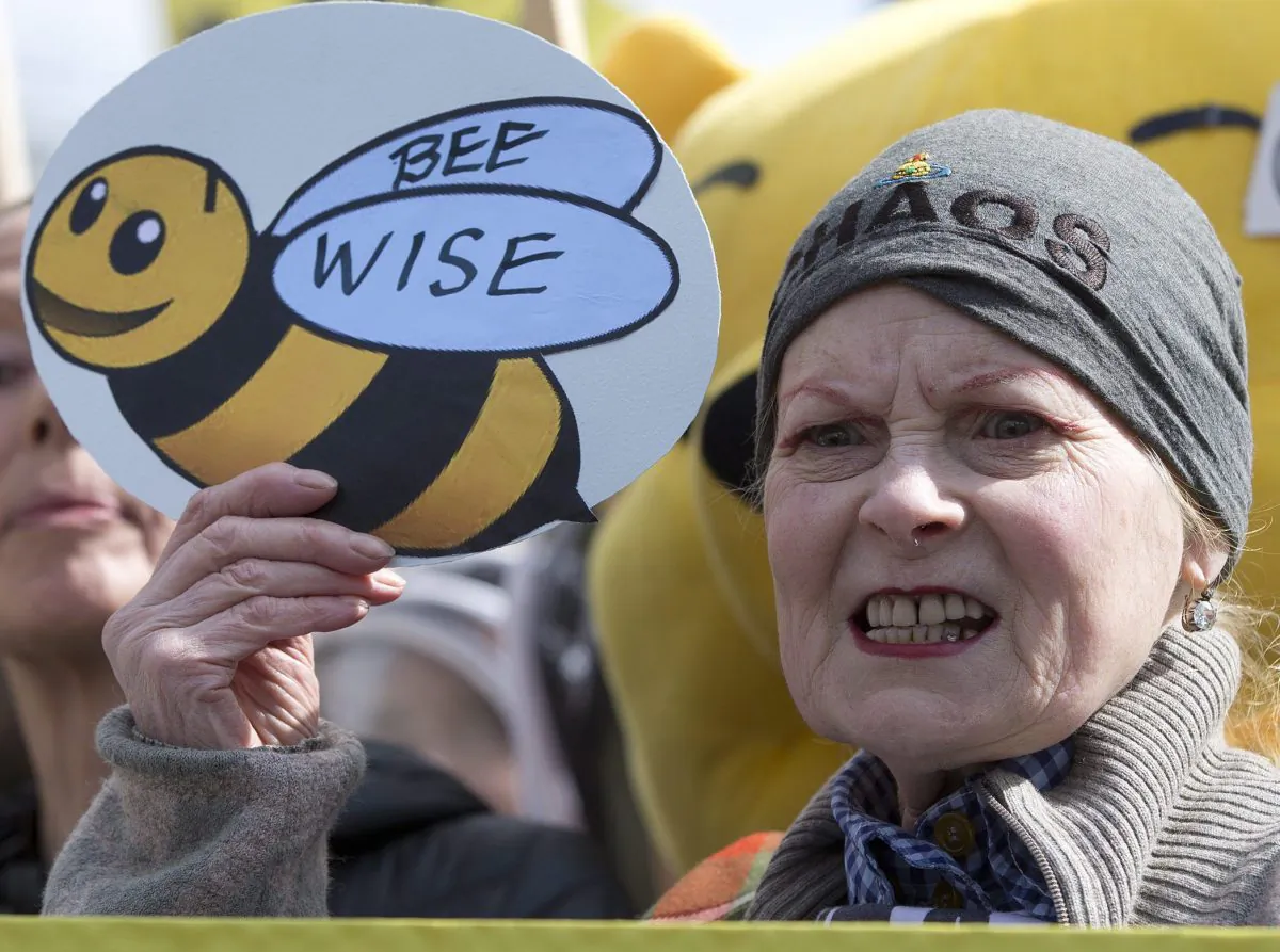 British fashion designer Vivienne Westwood holds a sign supporting bee-keepers during a demonstration in London ahead of the European Commission’s vote on a proposal to ban bee-harming neonicotinoid pesticides, April, 26, 2013. (AP Photo/Alastair Grant)