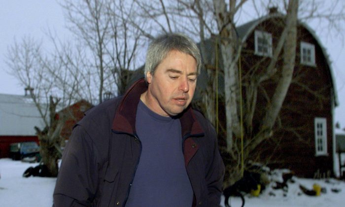 Robert Latimer walks on his farm near Wilkie, Sask., after speaking to reporters in January 2001. Latimer is seeking to overturn a parole board decision that makes it onerous for him to travel internationally. (CP PHOTO/Kevin Frayer)