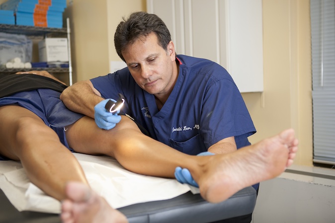 Dr. Ronald Lev of Advanced Varicose Veins demonstrates  treatments in his office in Manhattan, Aug. 19, 2014. (Samira Bouaou/Epoch Times)

