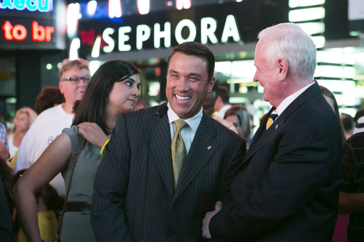 (L-R) New York State Assembly Member Nicole Malliotakis, United States Congressman Michael Grimm, New York State Senator Martin Golden, join families in Times Square to support pediatric cancer awareness where more than a dozen iconic digital screens simultaneously illuminated in gold with a message about pediatric cancer in Times Square, New York, Sept. 2, 2014. (Samira Bouaou/Epoch Times)