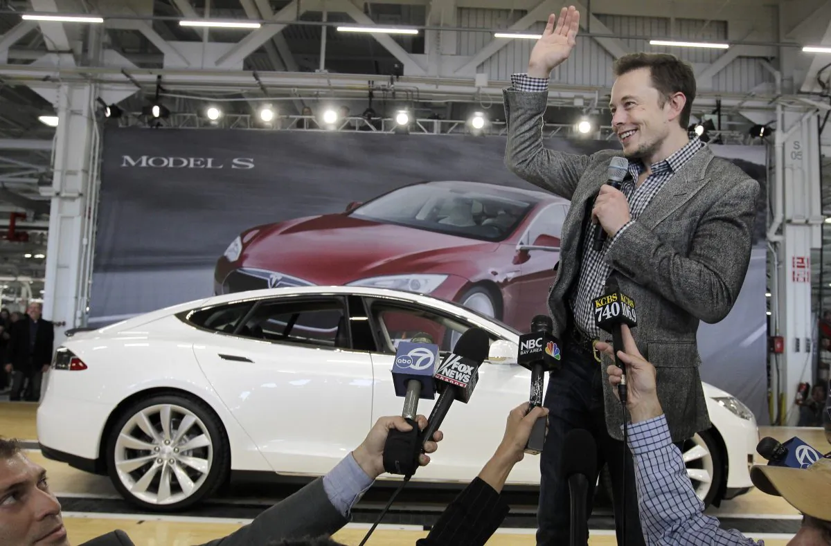 FILE - In this June 22, 2012 file photo, Tesla CEO Elon Musk waves during a rally at the Tesla factory in Fremont, Calif. Tesla Motors has selected Nevada for a massive, $5 billion factory that it will build to pump out batteries for a new generation of electric cars, a person familiar with the company's plans said Wednesday, Sept. 3, 2014. (AP Photo/Paul Sakuma, File)