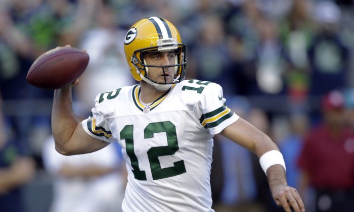 Green Bay Packers quarterback Aaron Rodgers passes against the Seattle Seahawks in the first half of an NFL football game, Thursday, Sept. 4, 2014, in Seattle. (AP Photo/Stephen Brashear)