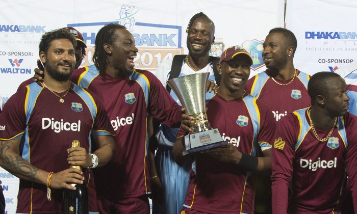 The West Indies team poses with the Dhaka Bank Cup after winning the One Day International series between the West Indies and Bangladesh 3 to nil at the Warner Park cricket ground in Basseterre, Saint Kitts and Nevis, August 25, 2014. (Jim Watson/AFP/Getty Images)