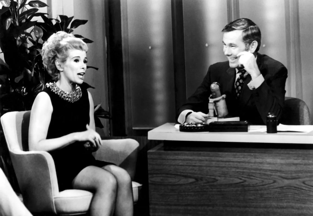 This undated image released by NBC shows comedian Joan Rivers, left, and host Johnny Carson during "The Tonight Show Starring Johnny Carson," in Burbank, Calif. Rivers, the raucous, acid-tongued comedian who crashed the male-dominated realm of late-night talk shows and turned Hollywood red carpets into danger zones for badly dressed celebrities,  died Thursday, Sept. 4, 2014. She was 81. Rivers was hospitalized Aug. 28, after going into cardiac arrest at a doctor's office.  (AP Photo/NBC)
