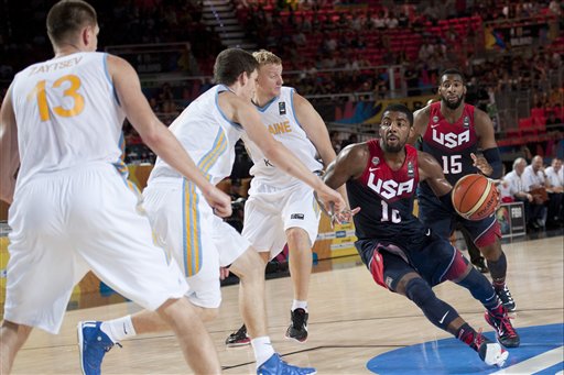 Kyrie Irving of the US goes for the basket between Ukraine players during the Group C Basketball World Cup match, in Bilbao northern Spain, Thursday, Sept. 4, 2014. The 2014 Basketball World Cup competition take place in various cities in Spain from Aug. 30 through to Sept. 14.  United States won 95-71. (AP Photo/Alvaro Barrientos)