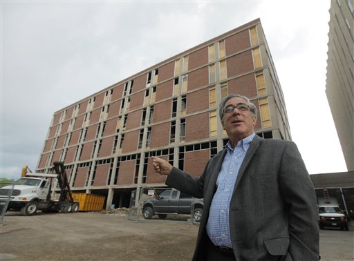 In this June 24, 2010 photo, developer Larry Glazer gestures toward a building to be demolished on Alexander Street in Rochester, N.Y. Glazer and wife, Jane, were aboard their small plane, which took off from the Greater Rochester International Airport, as it flew 1,700 miles down the East Coast on Friday, Sept. 5, 2014, before finally crashing off the coast of Jamaica. (AP Photo/Democrat & Chronicle, Carlos Ortiz)  