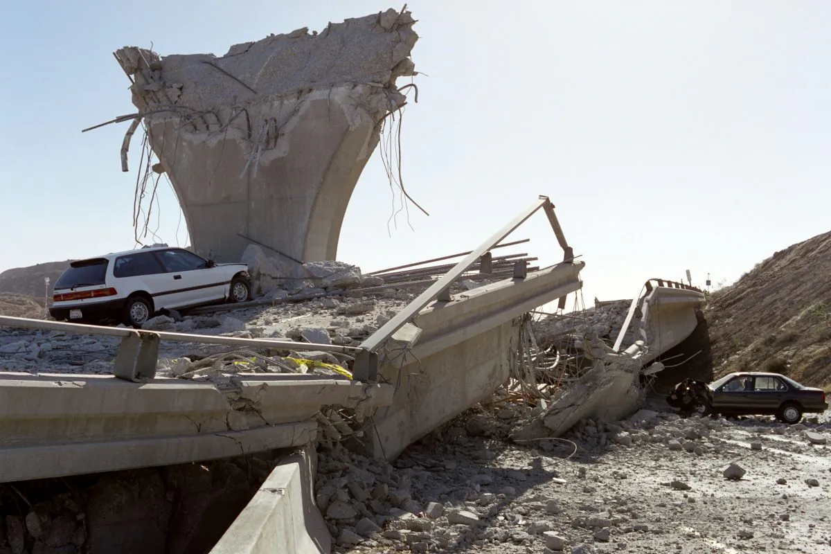 Cars lie smashed by the collapsed Interstate 5 connector ramp on Jan. 17, 1994, following a 6,6 earthquake, California. (Jonathan Nourok/AFP/Getty Images)