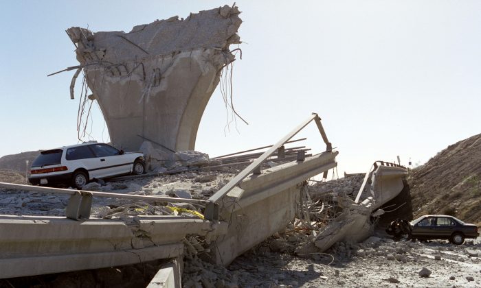 Cars lie smashed by the collapsed Interstate 5 connector ramp on Jan. 17, 1994, following a 6,6 earthquake, California. (Jonathan Nourok/AFP/Getty Images)