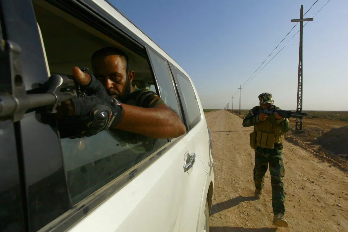 Shiite Muslim fighters, loyal to Iraqi Shiite cleric Moqtada al-Sadr, take part in a last combat training near the city of Najaf on Aug. 23, 2014, before joining the government forces to fight Islamic State (IS) jihadists in the Jurf al-Sakhr area, south of Baghdad.  (Haidar Hamdani/AFP/Getty Images)
