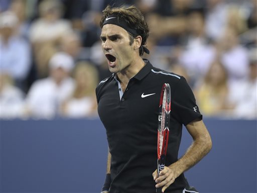 Roger Federer, of Switzerland, reacts after winning the fourth set against Gael Monfils, of France, during the quarterfinals of the U.S. Open tennis tournament, Thursday, Sept. 4, 2014, in New York. Federer won 4-6, 3-6, 6-4, 7-5, 6-2. (AP Photo/John Minchillo)