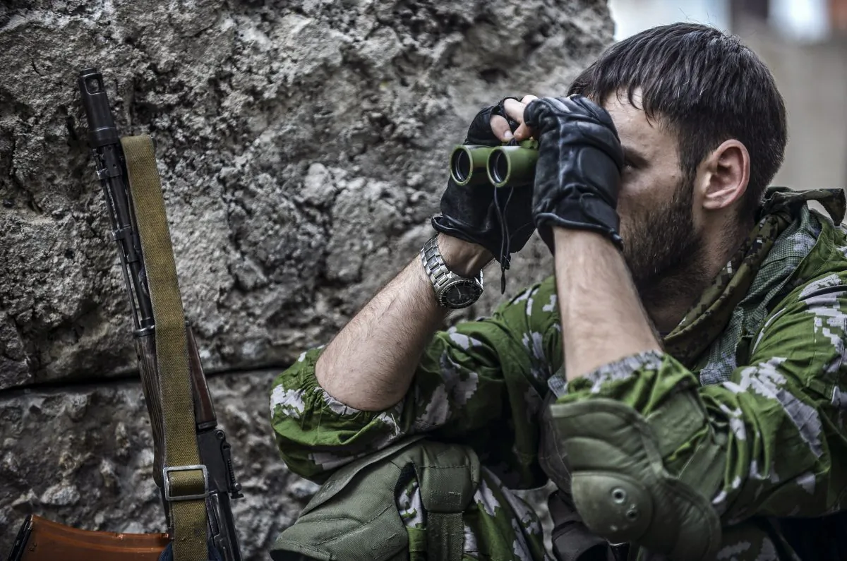 A pro-Russian separatist checks the Ukrainian army position with binoculars at a checkpoint  in the northern outskirts of city of Donetsk, on July 22, 2014. (Bulent Kilic/AFP/Getty Images)