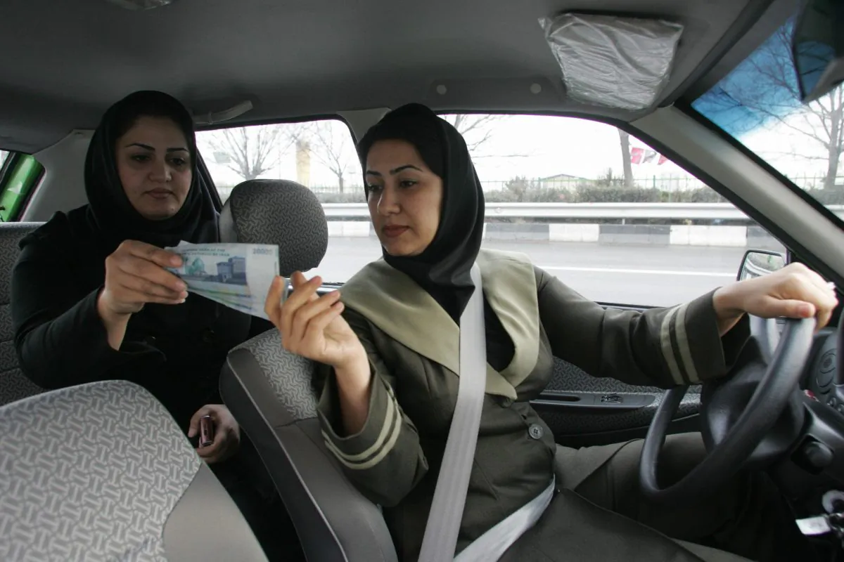 A file photo of an Iranian woman paying a female taxi driver in a women-only cab at the end of her trip in the capital Tehran (Atta Kenare/AFP/Getty Images)