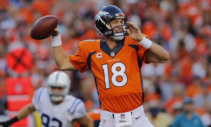 Denver Broncos quarterback Peyton Manning (18) throws against the Indianapolis Colts during the first half of an NFL football game, Sunday, Sept. 7, 2014, in Denver. (AP Photo/Joe Mahoney)