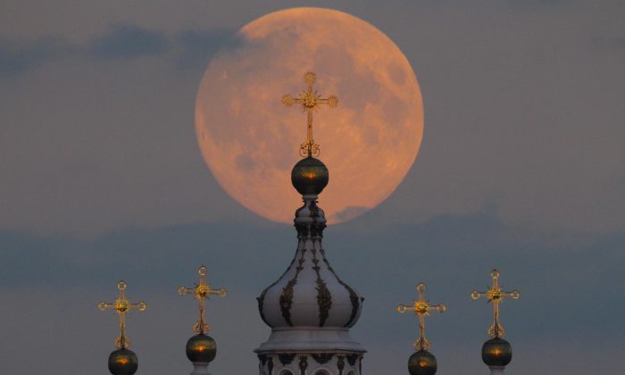 The full moon is seen rising in the sky above the domes of the Smolny Cathedral in St. Petersburg, Russia, Monday, Sept. 8, 2014. Monday night's full moon, also known as a Harvest Moon, will be the third and final "supermoon" of 2014. The phenomenon, which scientists call a "perigee moon," occurs when the moon is near the horizon and appears larger and brighter than other full moons. One of St. Petersburg landmarks, the Smolny convent's main church was built between 1748 and 1764 by Italian architect Francesco Bartolomeo Rastrelli. (AP Photo/Dmitry Lovetsky)