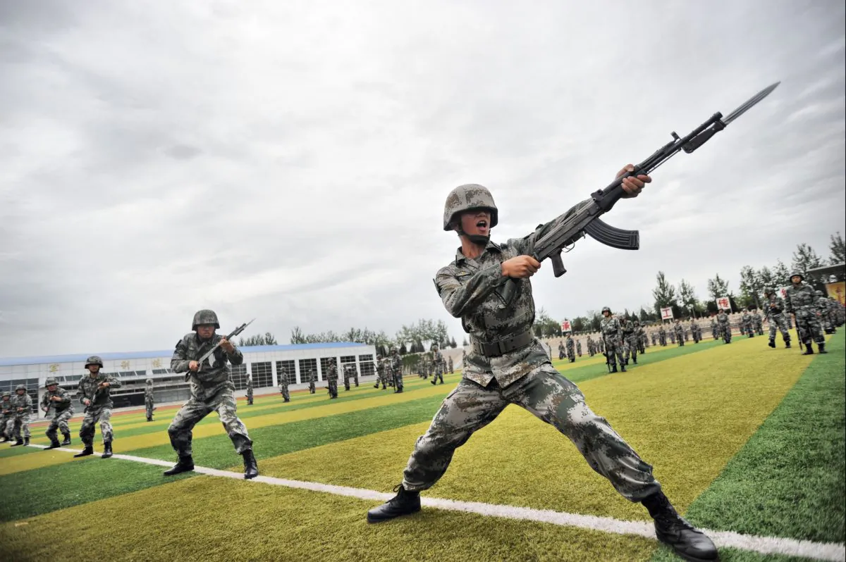 Soldiers perform military exercises in Beijing on July 22, 2014. Massive military exercises extending from July to September may have been directed at keeping a lid on the domestic political situation, argues Chen Pokong. (ChinaFotoPress via Getty Images)