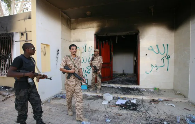 In this Sept. 14, 2012, photo Libyan military guards check one of the US consulate's burned buildings in Benghazi, after a deadly attack on Sept. 11, 2012, that killed four Americans.  (AP Photo/Mohammad Hannon)