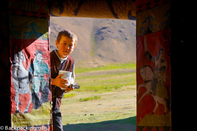 Boy brings tea into the yurt. (Jonny Duncan, Backpacking Man)