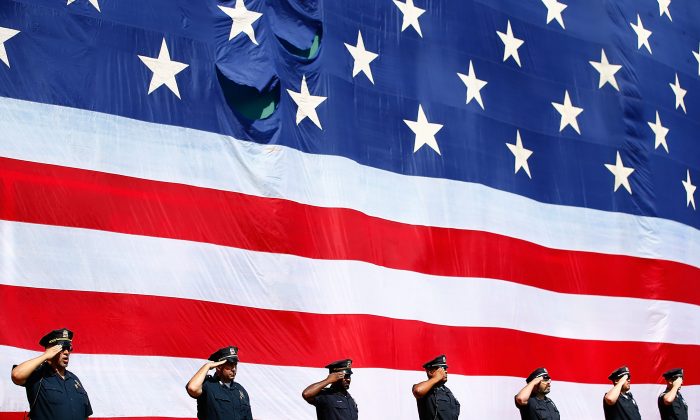 Members of the Boston Police Department line up along the Green Monster during a pregame ceremony remembering first responders from 9/11 prior to the game between the Boston Red Sox and the Baltimore Orioles at Fenway Park on September 10, 2014 in Boston, Massachusetts. ((Jared Wickerham/Getty Images)