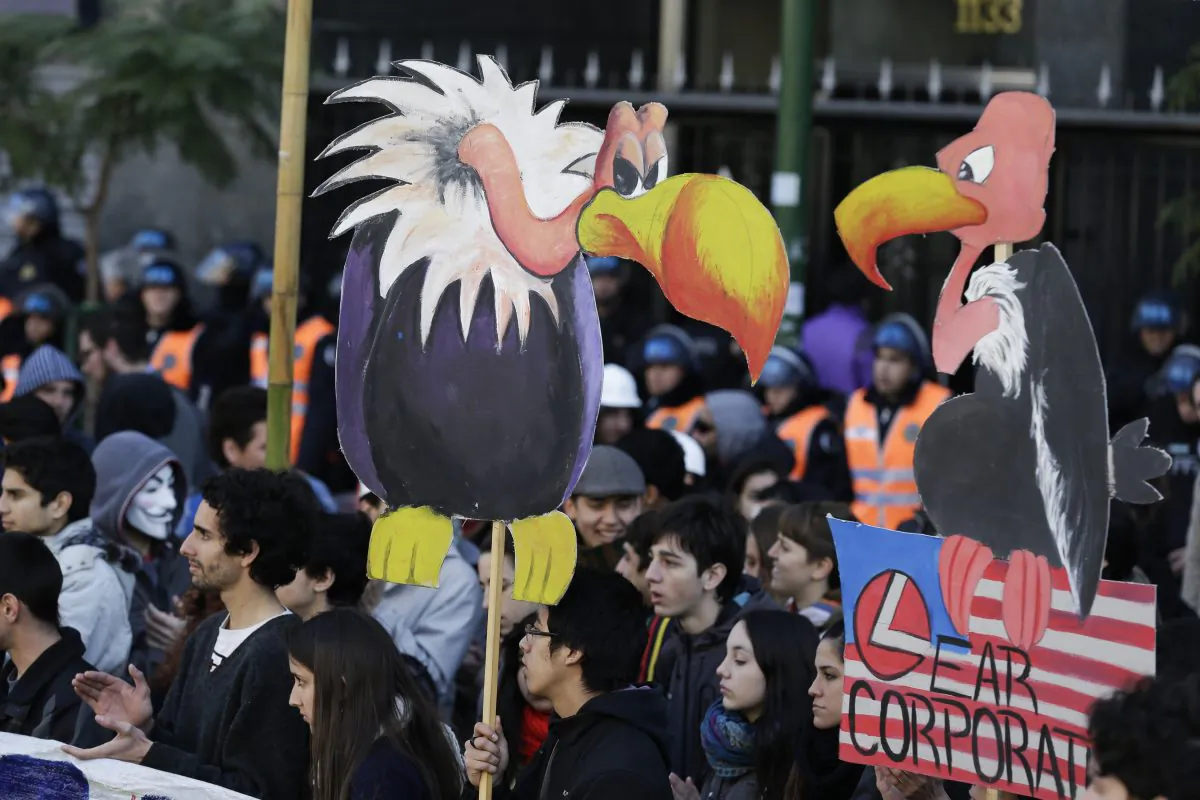 Protesters hold cutouts of vultures during a demonstration in front of the U.S. Chamber of Commerce in Buenos Aires, Argentina, on Aug. 15, 2014. Students gathered to protest against the recent closing of U.S. company R.R. Donnelley & Sons printing plant on the outskirts of the Argentine capital, the layoffs of about 60 workers at the American car parts maker Lear and against the ruling by U.S. Judge Thomas Griesa in favor of a U.S. hedge fund, known locally as "vulture funds." (AP Photo/Victor R. Caivano)