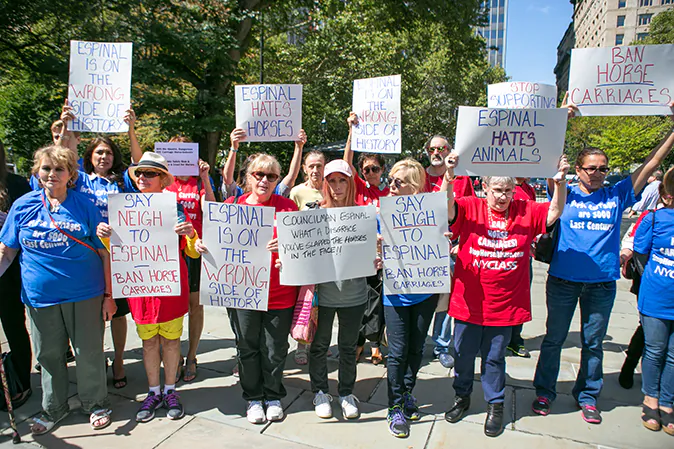 Protesters gather in support of the horse-drawn carriage ban at City Hall during Council member Rafael Espinal's press conference who suports the ban in Manhattan on Sept. 10, 2014. (Benjamin Chasteen/Epoch Times)