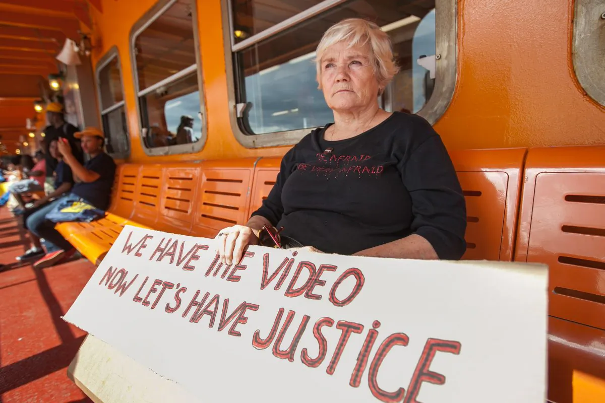 Karen Hofmann, 71, on her way to a rally against police brutality on Staten Island, Aug. 23, 2014. The rally was prompted by the death of Eric Garner during a police arrest where he was put in a chokehold by police. The act was captured on video by a passerby. Its public release prompted a storm of complaints, as well as reforms at the NYPD and the independent Civilian Complaint Review Board. (Petr Svab/Epoch Times)