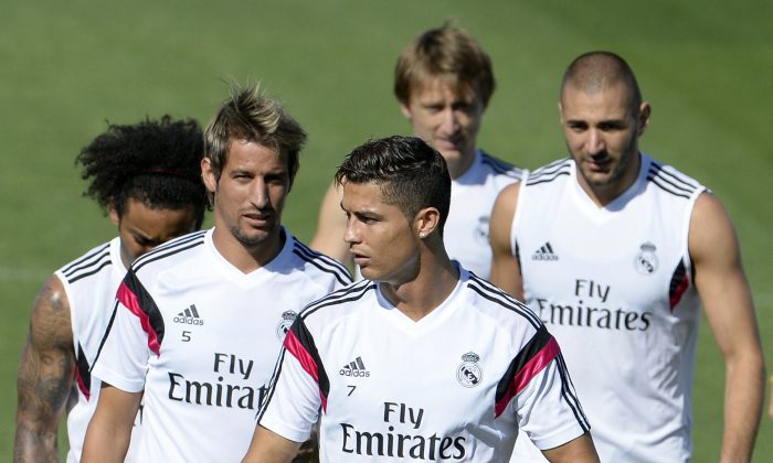 Real Madrid's Brazilian defender Marcelo, Real Madrid's Portuguese defender Fabio Coentrao, Real Madrid's Portuguese forward Cristiano Ronaldo and Real Madrid's French forward Karim Benzema take part in a training session at Valdebebas training ground in Madrid on September 12, 2014, on the eve of the Spanish League football match Real Madrid CF vs Club Atletico de Madrid . (GERARD JULIEN/AFP/Getty Images)