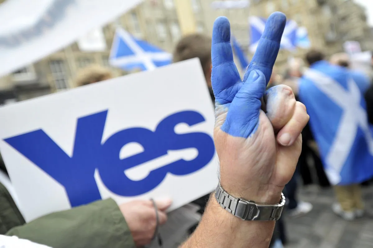 A pro-independence supporter flashes the victory sign as people gather in Edinburgh, Scotland, on Sept. 21, 2013, for a march and rally in support of a “yes” vote in the Scottish Referendum to be held on Sept. 18, 2014. (Andy Buchanan/AFP/Getty Images)