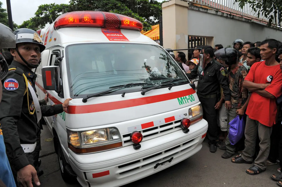 Cambodian military police stand guard as an ambulance drives past a crowd in front of a hospital in Phnom Penh on Nov. 23, 2010. A military hospital in Cambodia was recently raided after it ran an organ trafficking ring that involved at least one Chinese doctor. (Tang Chhin Sothy/AFP/Getty Images)