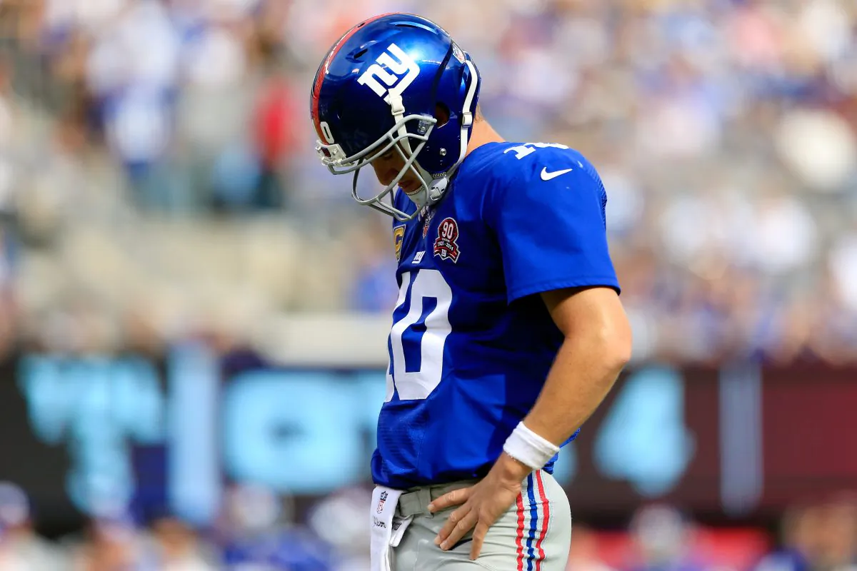 EAST RUTHERFORD, NJ - SEPTEMBER 14: Quarterback Eli Manning #10 of the New York Giants reacts after a fumble in the fourth quarter against the Arizona Cardinals during a game at MetLife Stadium on September 14, 2014 in East Rutherford, New Jersey. (Photo by Alex Trautwig/Getty Images)