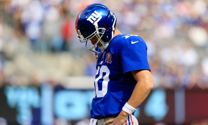 EAST RUTHERFORD, NJ - SEPTEMBER 14: Quarterback Eli Manning #10 of the New York Giants reacts after a fumble in the fourth quarter against the Arizona Cardinals during a game at MetLife Stadium on September 14, 2014 in East Rutherford, New Jersey. (Photo by Alex Trautwig/Getty Images)