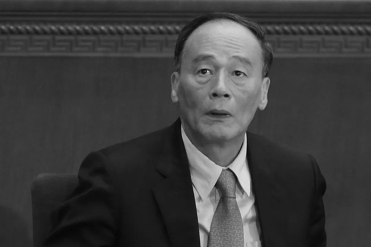 China's Politburo Standing Committee member Wang Qishan attends the opening session of the National People's Congress at the Great Hall of the People in Beijing on March 5, 2014. (Feng Li/Getty Images)