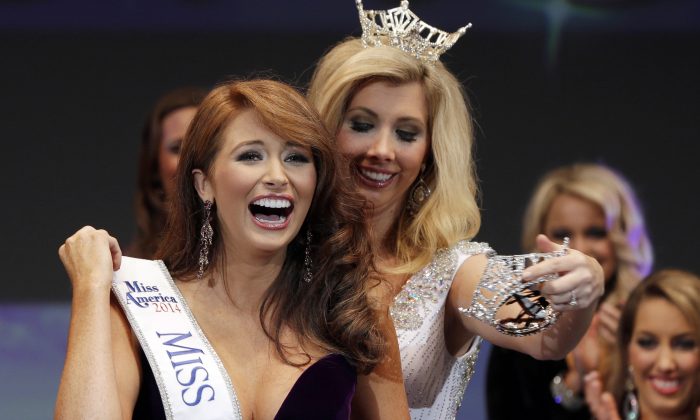 Ashton Campbell, left, celebrates being named Miss Arkansas with last year's winner Amy Crain at the Miss Arkansas Pageant in Hot Springs, Ark., Saturday, June 21, 2014. (AP Photo/Danny Johnston)