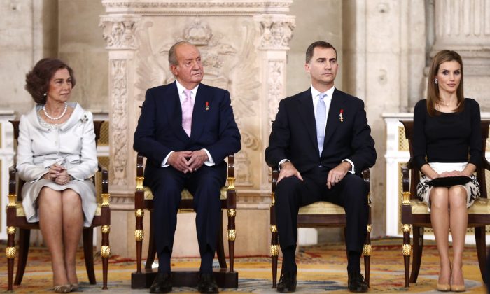 Spain's Queen Sofia, left sits with King Juan Carlos, 2nd left, Spanish Crown Prince Felipe, 3rd left and Princess Letizia before signing an abdication law during a ceremony at the Royal Palace in Madrid, Spain, Wednesday June 18, 2014. Spains Juan Carlos formally ratified the law, signing a legislation setting out the legal framework for the handover so his 46-year-old son can be proclaimed King Felipe VI at a ceremony in Parliament on Thursday. The 76-year-old monarch says he wants to step aside after a four-decade reign so that younger royal blood can rally a country beset by economic problems, including an unemployment rate of 25 percent. (AP Photo/Daniel Ochoa de Olza)
