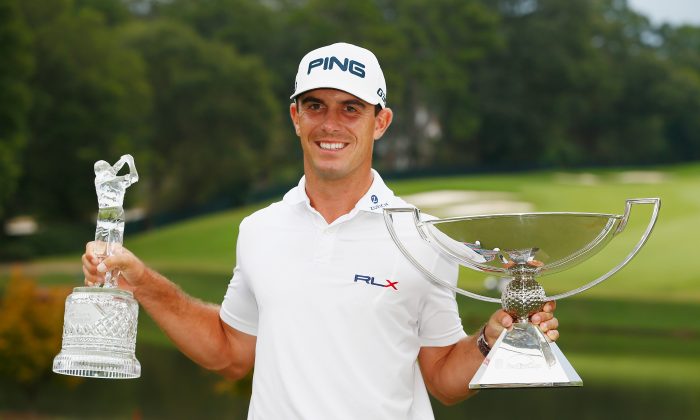 Billy Horschel poses on the 18th green after winning both the TOUR Championship and the FedExCup Playoffs at the East Lake Golf Club. (Sam Greenwood/Getty Images) 