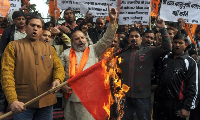 Activists of the Indian right-wing Hindu organization Shiv Sena shout slogans as they burn a China national flag while protesting land grabs by China in Ladakh during a demonstration in Amritsar on April 25, 2013. On Monday, the Chinese army again transgressed into the Ladakh region just days before Chinese leader Xi Jinping's scheduled visit to India. (Narinder Nanu/AFP/Getty Images)