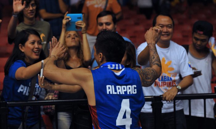 Philippines' guard Jim Alapag celebrates with his supporters after winning the 2014 FIBA World basketball championships group B match Senegal vs Philippines at the Palacio Municipal de Deportes in Sevilla on September 4, 2014. Philippines won the match 81-79. (AFP/Getty Images)