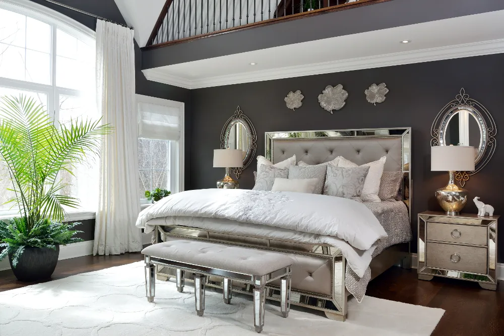 Dramatic silk-embroidered drapes grace the bedroom’s central window tableau while hobbled Roman shades accentuate the side windows. (Larry Arnal)