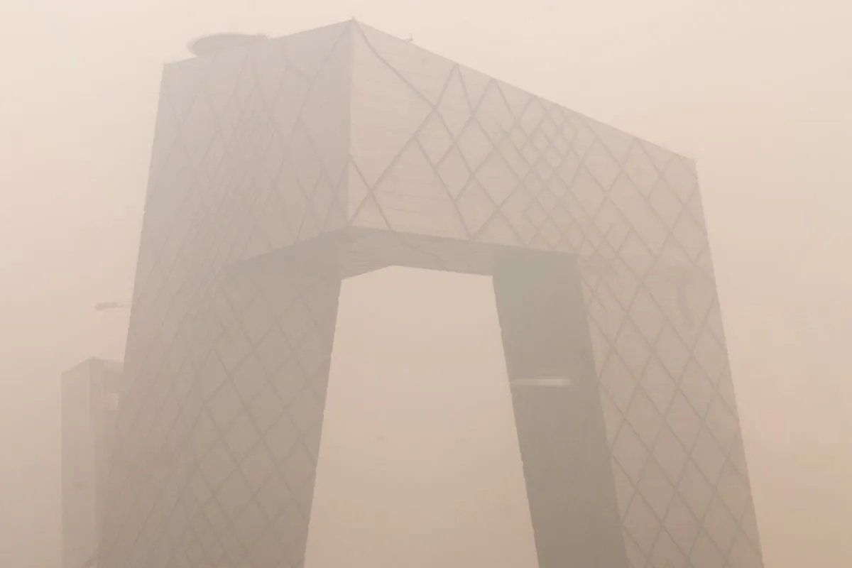Heavy pollution surrounds the China Central Television (CCTV) headquarters building in Beijing on Jan. 18, 2012. No announcement has been made about CCTV's New Year Gala next year, leading to speculation that it may have been axed amid scandal at the broadcaster. (Ed Jones/AFP/Getty Images)