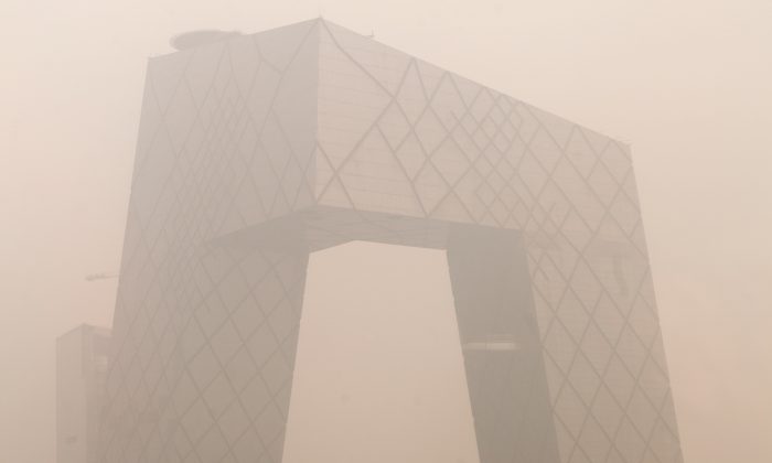 Heavy pollution surrounds the China Central Television (CCTV) headquarters building in Beijing on Jan. 18, 2012. No announcement has been made about CCTV's New Year Gala next year, leading to speculation that it may have been axed amid scandal at the broadcaster. (Ed Jones/AFP/Getty Images)